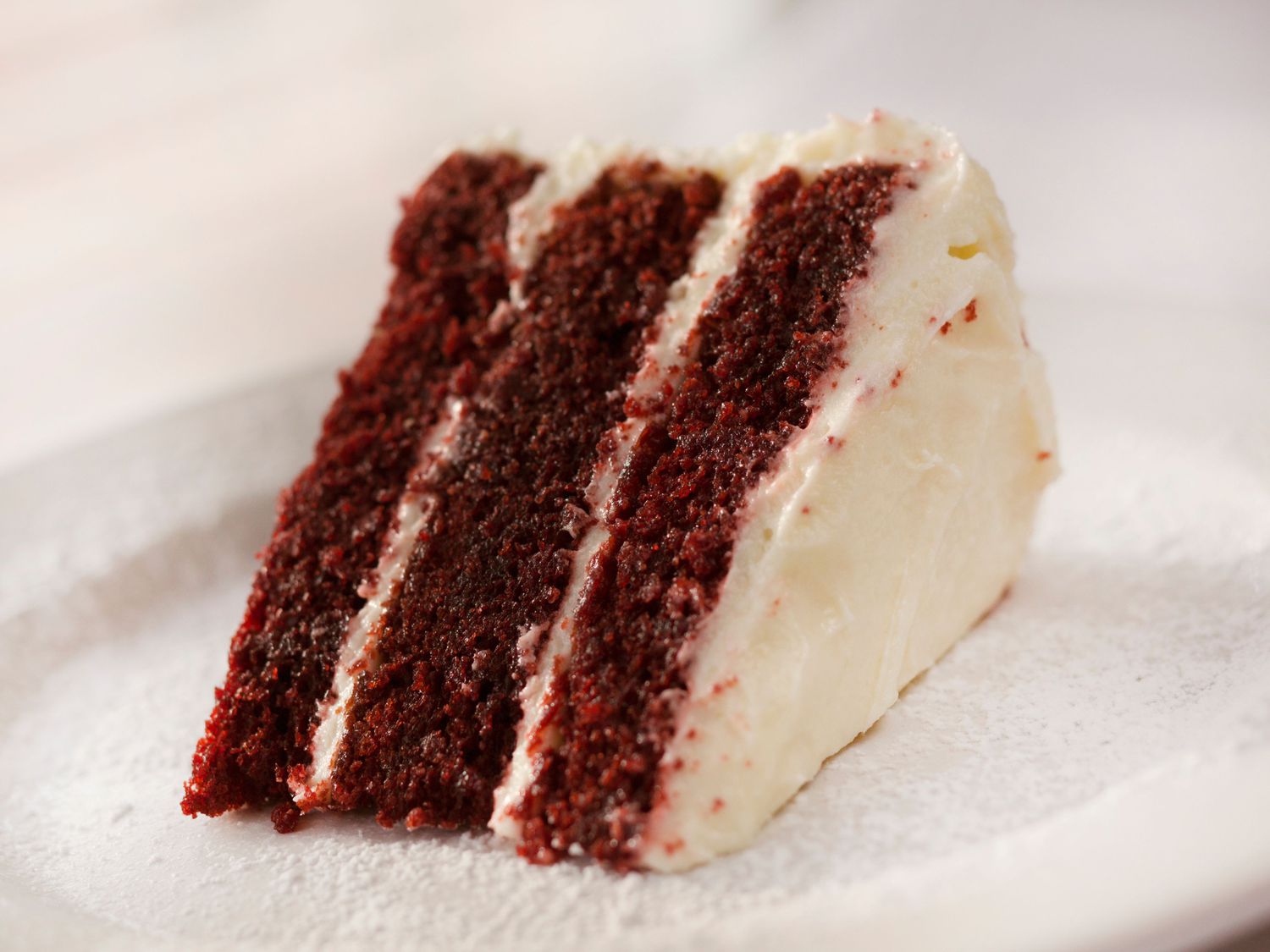 reddish-brown three-tier cake with white frosting